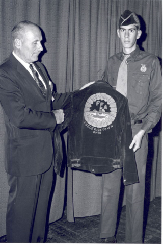 Blue corduroy jacket adopted as Official Dress.