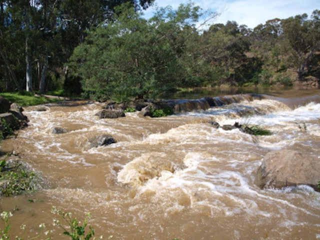 Timber remains are washed away in flood water