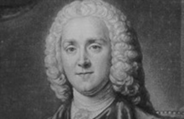Prime Minister George Grenville enacts the Stamp Act.