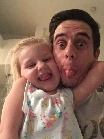 Conner teaches his step daughter to read through a children's book completely.