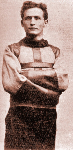 Harry Houdini frees himself from a straight jacket