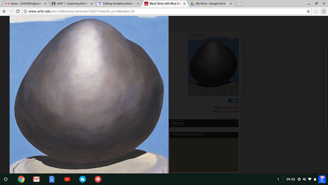 black rock with blue sky and white clouds