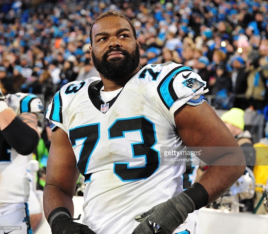 Michael Oher signs for the Carolina Panthers