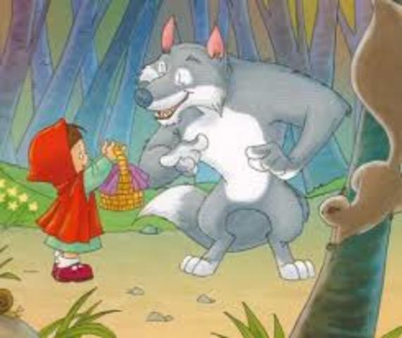 en el camino se encuentra un lobo, el cual le saca toda la información de hacia donde va porque quería que ella fuera la cena, pero no podía comerla por la presencia de muchos leñadores