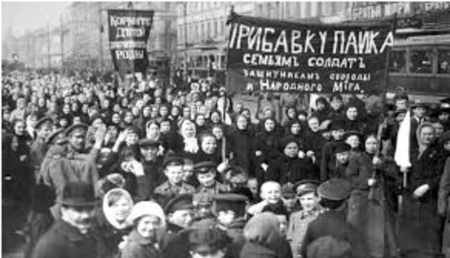 The February Revolution begins with strikes, demonstrations, and mutinies in Petrograd