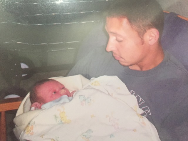 Dad holding me after being born.