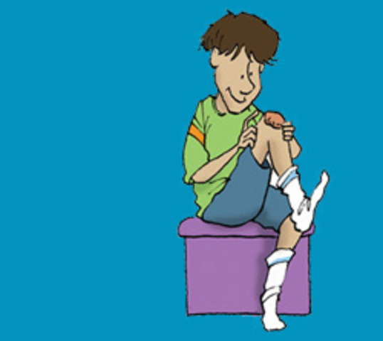 The boy picks his scab