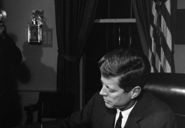 President Kennedy signs the Proclamation for Interdiction of the Delivery of Offensive Weapons to Cuba