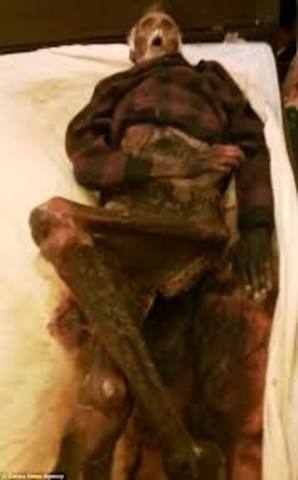 The townspeople break down the door of her upstairs room and find the corpse of Homer Barron.