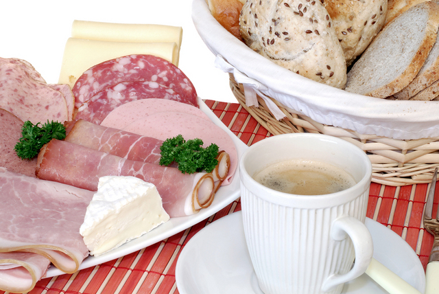 Herta introduces "German Breakfast" to an American girl.