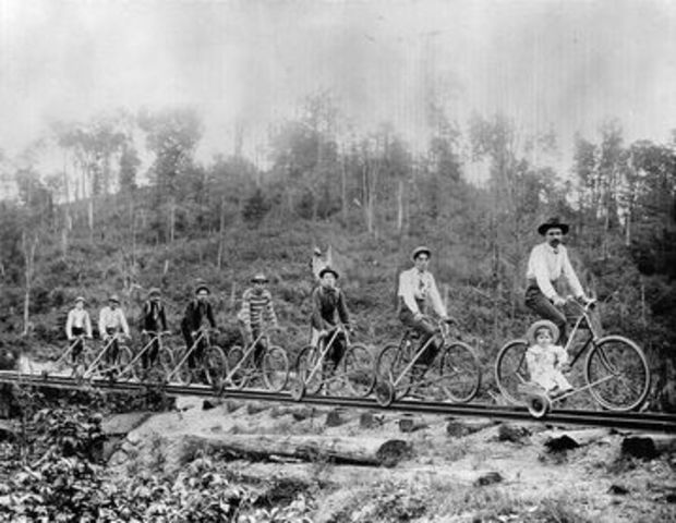 Bicyclists riding the rails, using attachments
