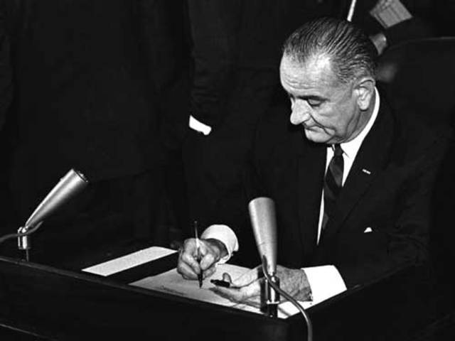 8/6/1965 President Johnson sings the Voting Rights Act.