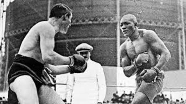 Jack Johnson beats Tommy Burns
