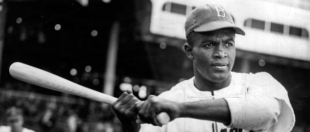 Jackie Robinson breaks barrier against colored players in Major League Baseball