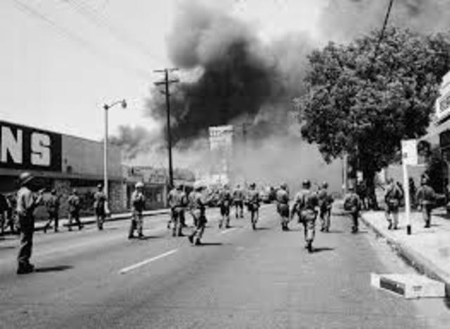 The Watts race riots in Los Angeles begin