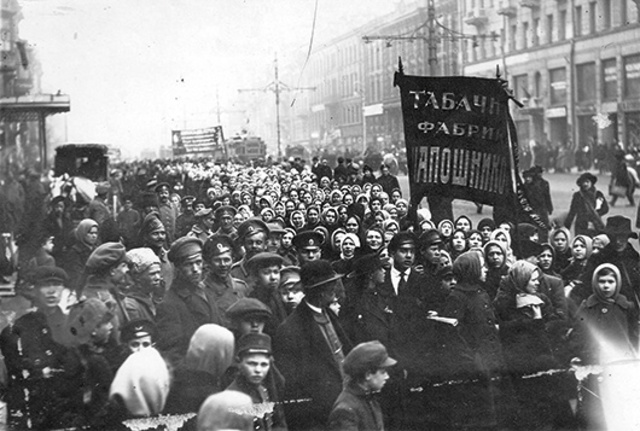 The February Revolution begins with strikes, demonstrations, and mutinies in Petrograd