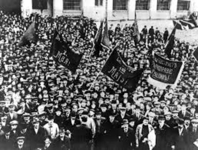 The February Revolution begins with strikes, demonstrations, and mutinies in Petrograd
