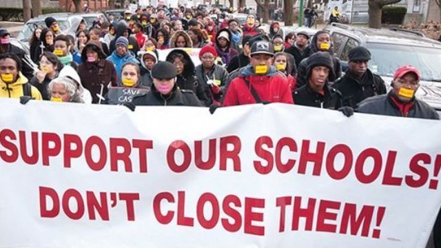 the Chicago Board of Education votes to close 50 schools