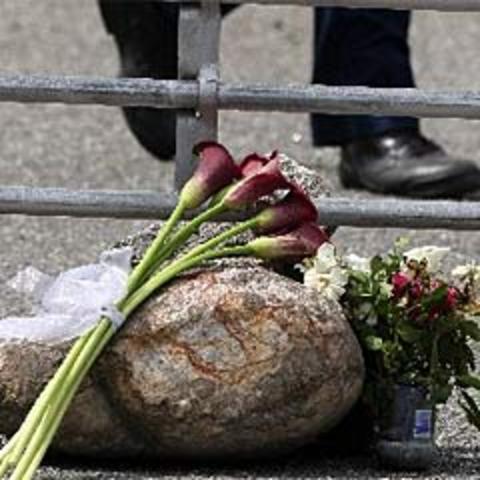 The families of the dead miners hold a memorial service at the mine.