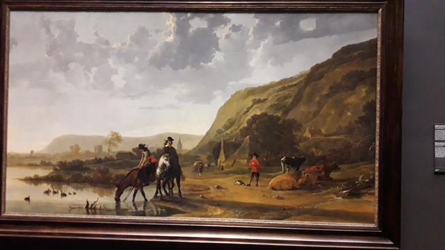 Rivierlandschap met ruiters