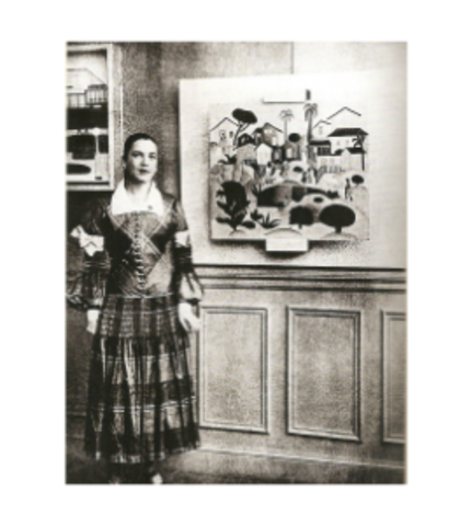 Picture of Tarsila’s First Solo Exhibition in Paris.  She’s attired in a marvelous dress from fashion designer Paul Poiret, and standing next to her painting Morro da Favela (Hill of the Favela)