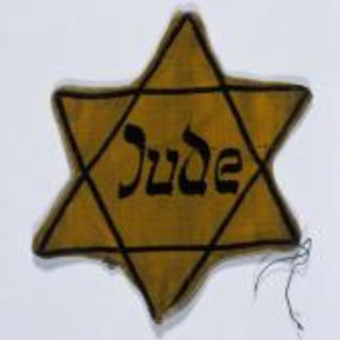 Jews are forced to wear the Star of David to identify them.