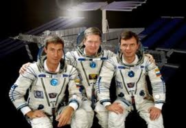 The crew of Expedition One, astronaut Bill Shepherd and cosmonauts Yuri Gidzenko and Sergei Krikalev, dock at the International Space Station.