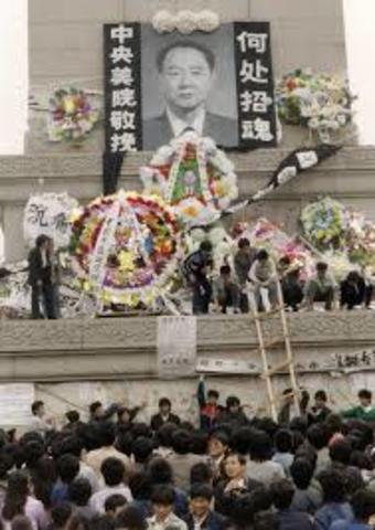 Students gather in Tiananmen Square to protest the death of Hu