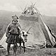Saami man with lavvo and reindeer