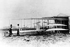 Orville pilots the first flight of the Wright Flyer I