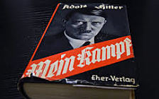 Hitler goes to prison and writes Mein Kampf