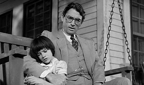 Scout finds out Atticus is defending Tom Robinson.