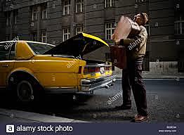 The Butler puts Mrs. Fosters luggage in the Taxi