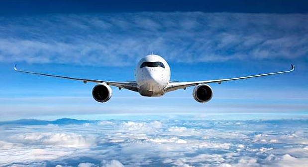 An unknown plane flies above the town.