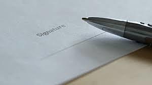 Eichmann signs court documents.