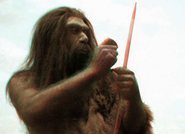 Neanderthal man carves a picture on a woolly mammoth tooth