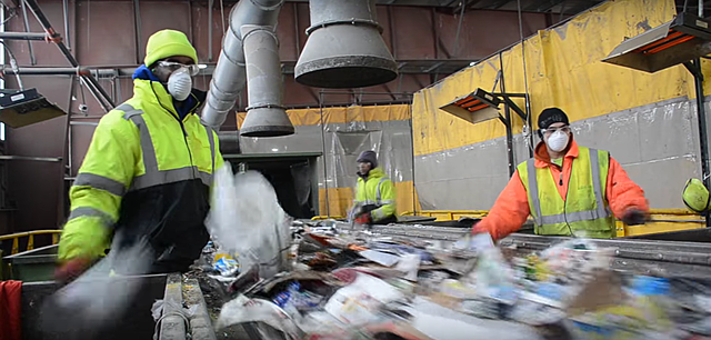 Workers sort through things that can not be recycled