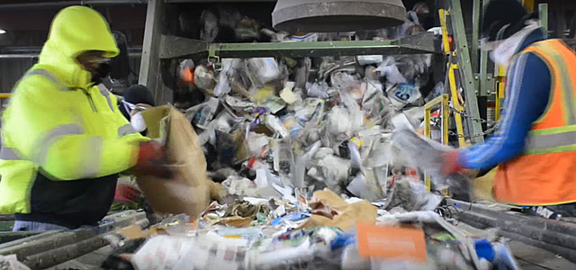 There is a wheel to catch the cardboard but some will get through so the workers grb it