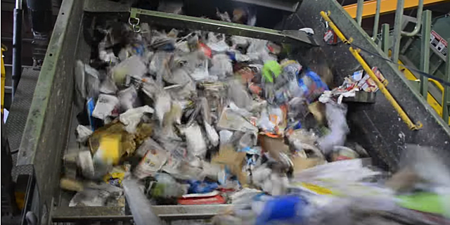 A screen that pumps air pushes the paper over and the containers below
