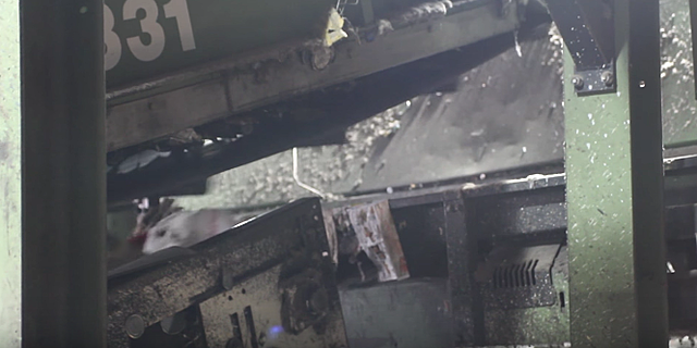 The tin cans are pulled away form the other containers with a magnet.