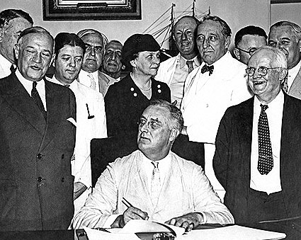 Signs the Agricultural "Adjustment Act.”