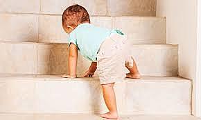 Baby is climbing up and down the stairs