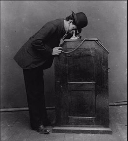 Coin-operated Kinetoscopes appear in a New York City amusement arcade.