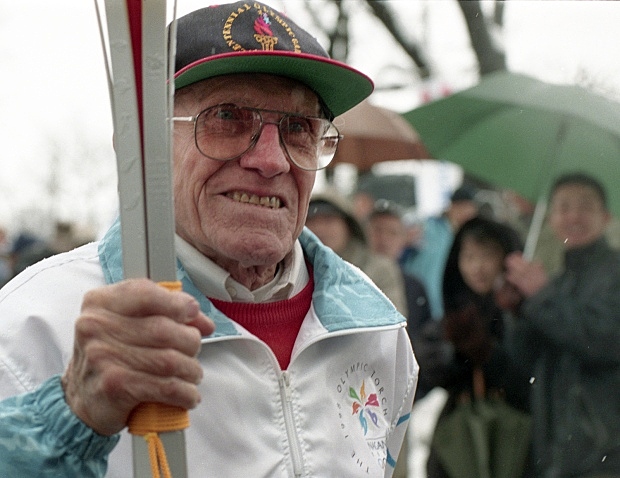 Louie Carrie the torch at the olympics
