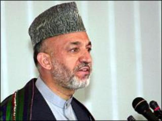 President Hamid Karzai signs the new constitution of Afghanistan.