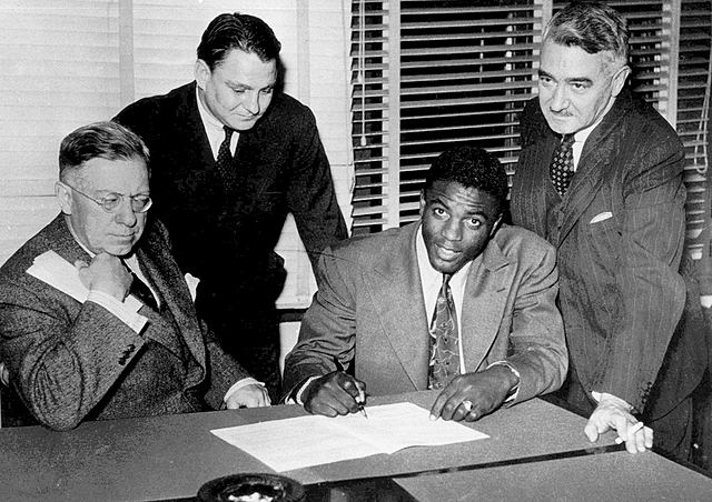 Jackie Robinson breaks Major League Baseball's color barrier when he signs with the brooklyn dodgers