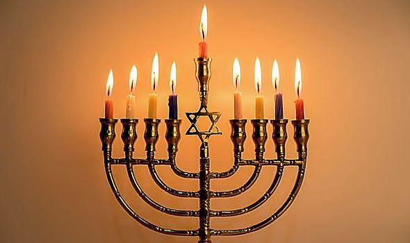 The Frank family, The Van Daan family, and Mr. Dussel celebrate Hanukah.