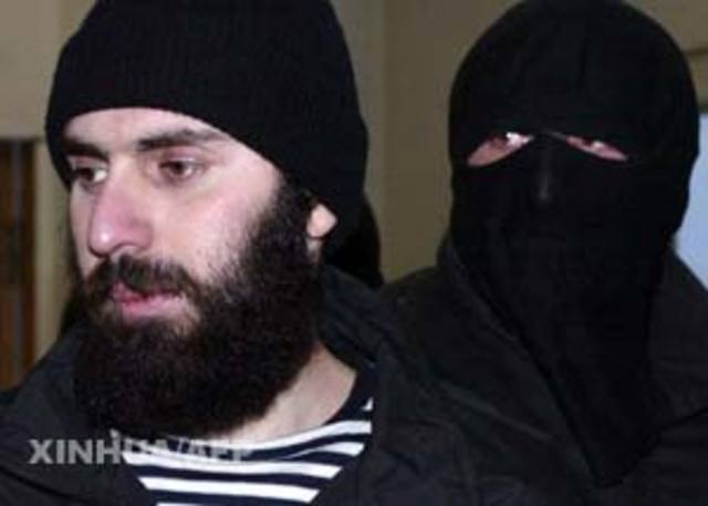 A hand grenade which was thrown by Vladimir Arutinian lands about 65 feet (20 metres) from U.S. President George W. Bush