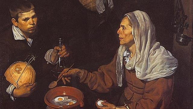 La vieja friendo huevos