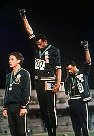 Track and field athletes raisea black power salute